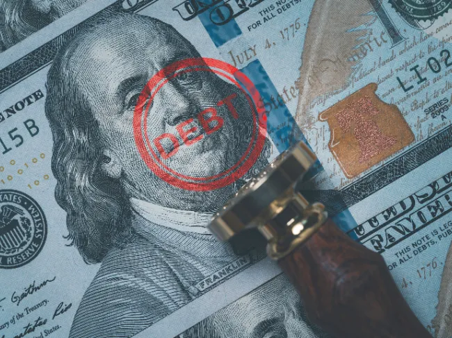 debt stamped on dollar